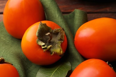 Delicious ripe juicy persimmons on wooden table