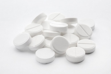 Heap of pills on white background