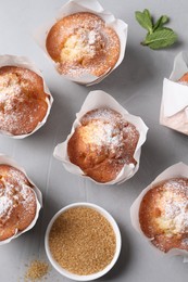 Delicious muffins on grey table, flat lay