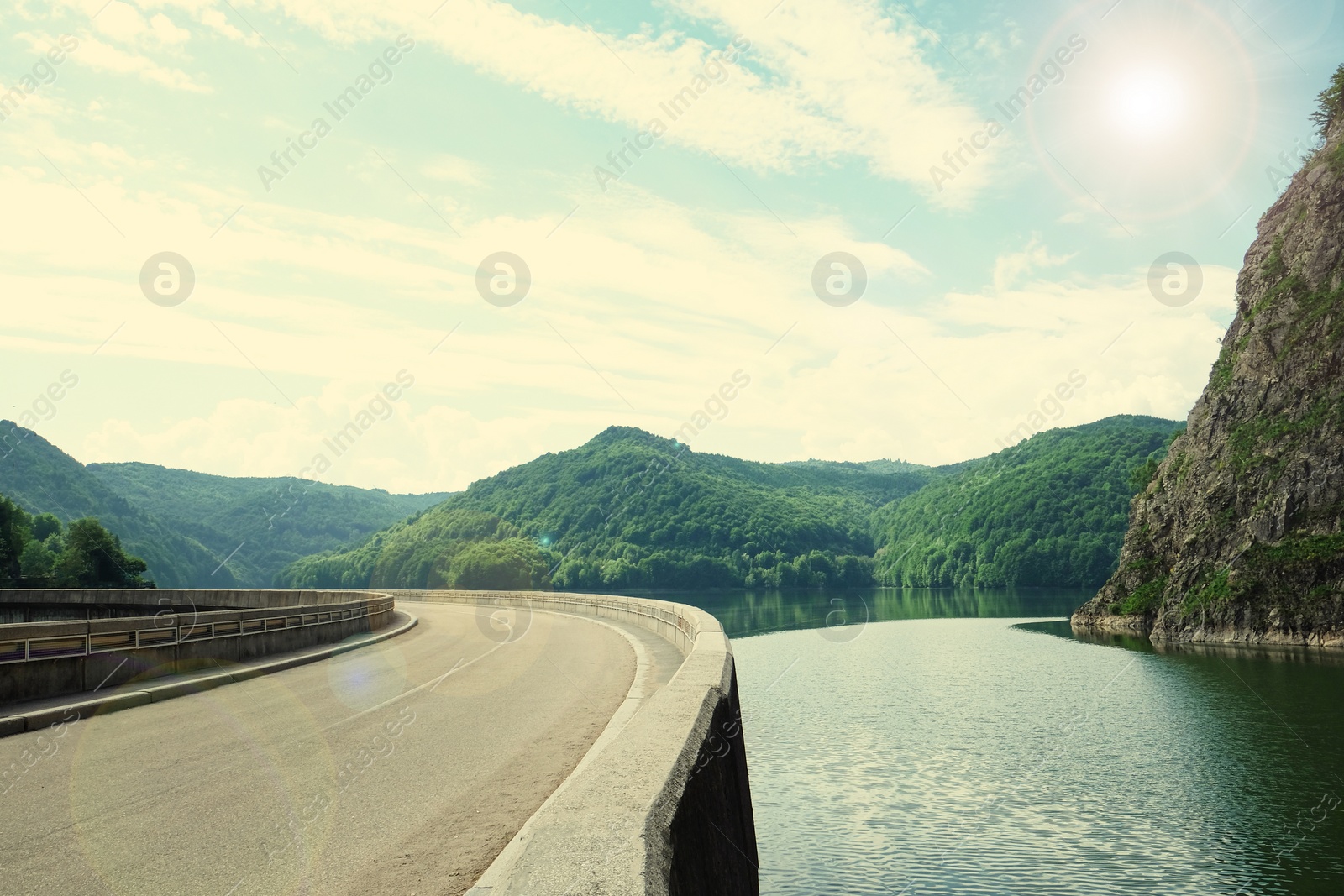 Image of Road trip. Beautiful view of asphalt highway along lake on sunny day 