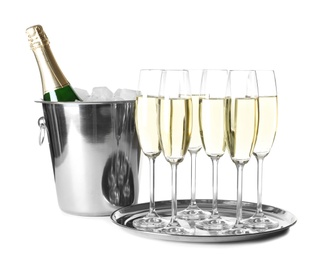 Glasses with champagne and bottle in bucket on white background