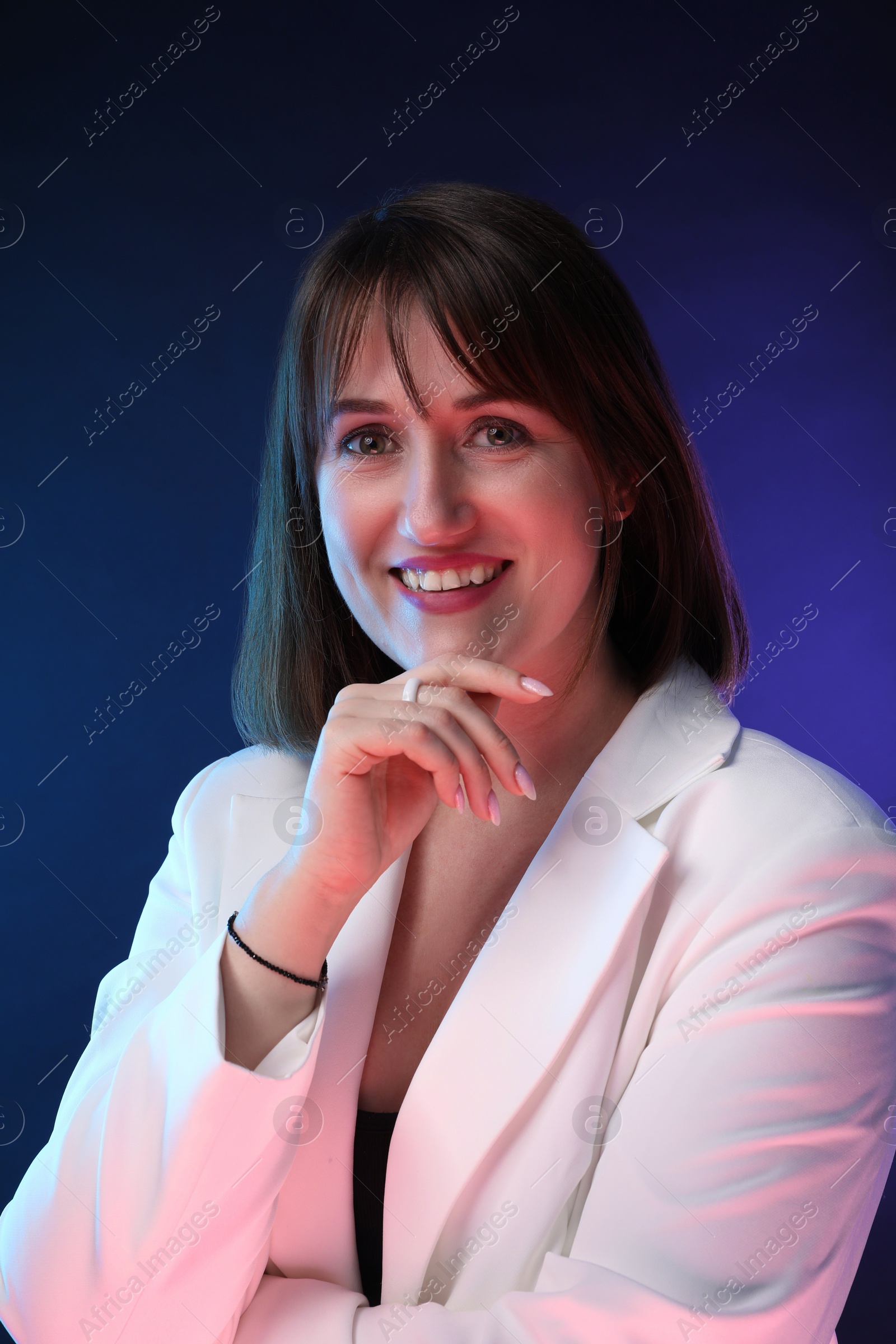 Photo of Portrait of happy woman on dark background