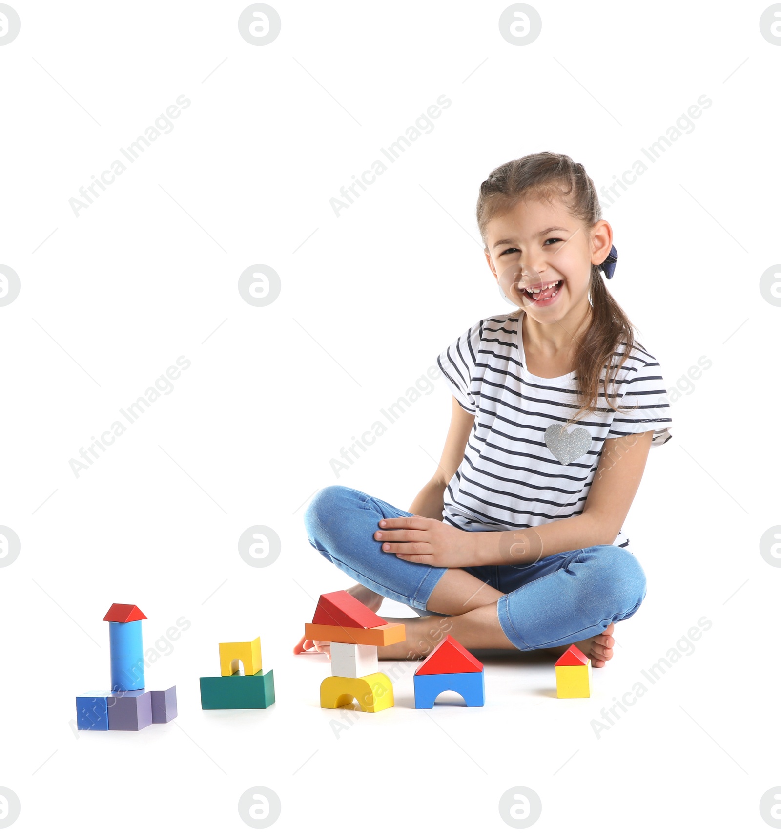 Photo of Cute child playing with colorful blocks on white background