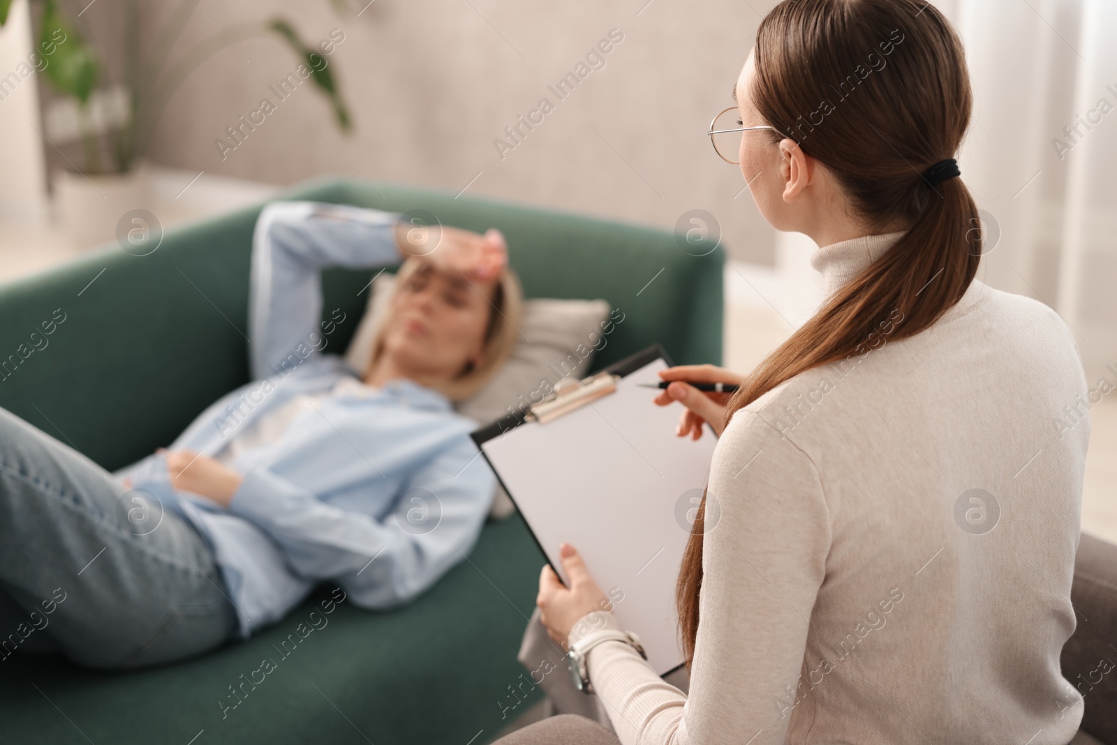 Photo of Professional psychotherapist working with patient in office