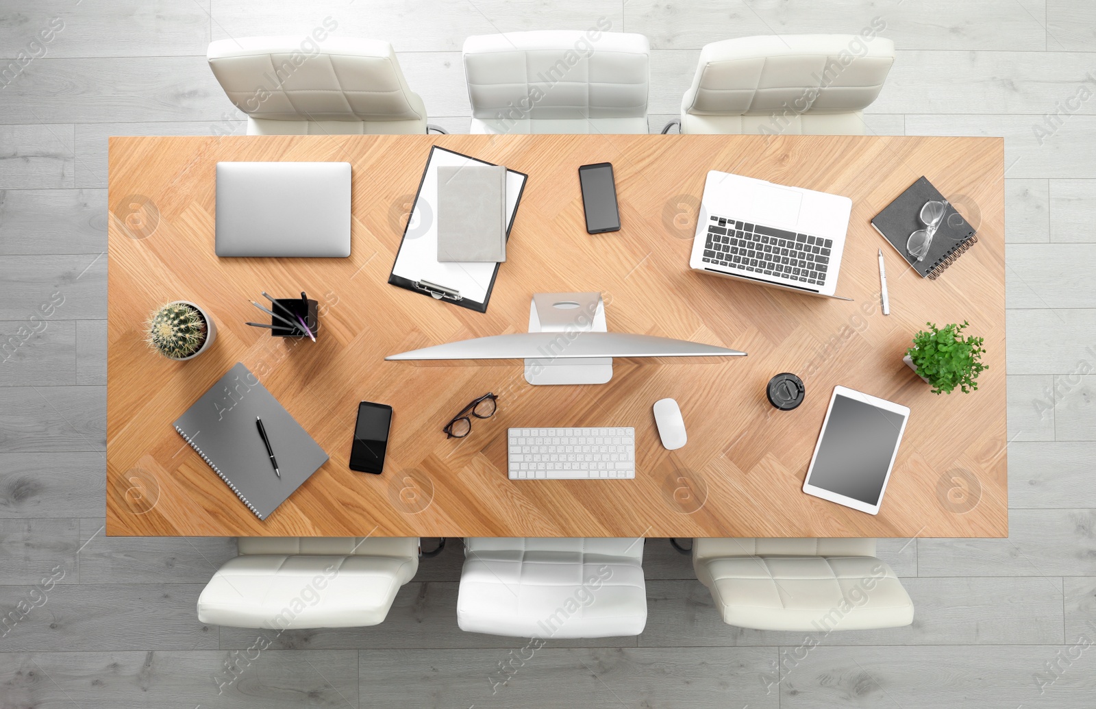 Photo of Modern office table with devices and chairs, top view