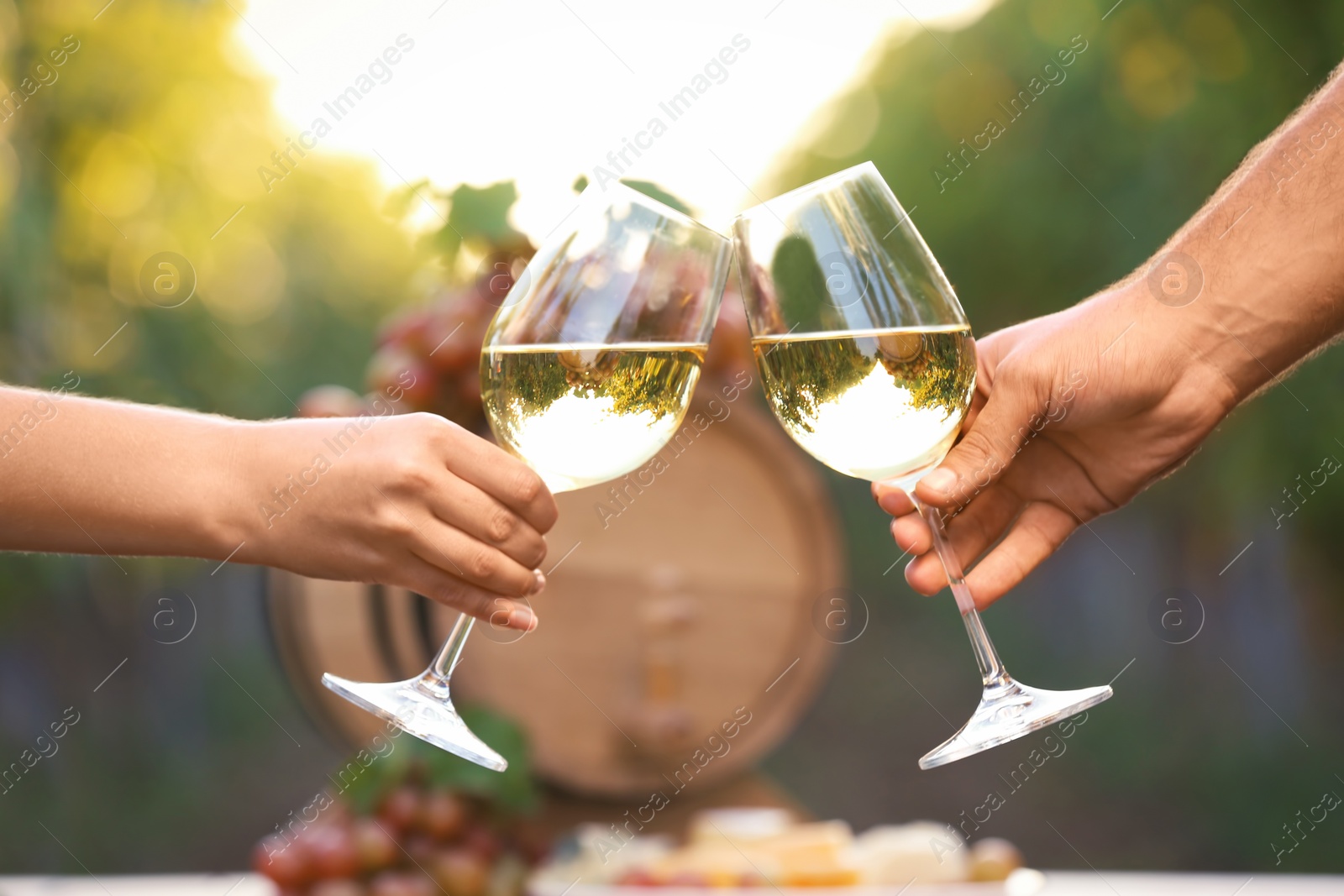 Photo of Couple with glasses of white wine outdoors, closeup