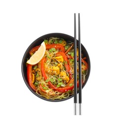 Photo of Stir-fry. Delicious cooked noodles with chicken and vegetables in bowl isolated on white, top view