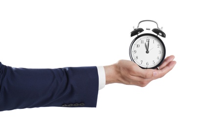 Young businessman holding clock on white background. Time management