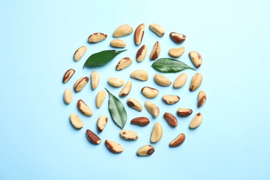 Photo of Flat lay composition with Brazil nuts on color background
