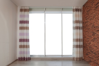 Big window with curtains in living room interior