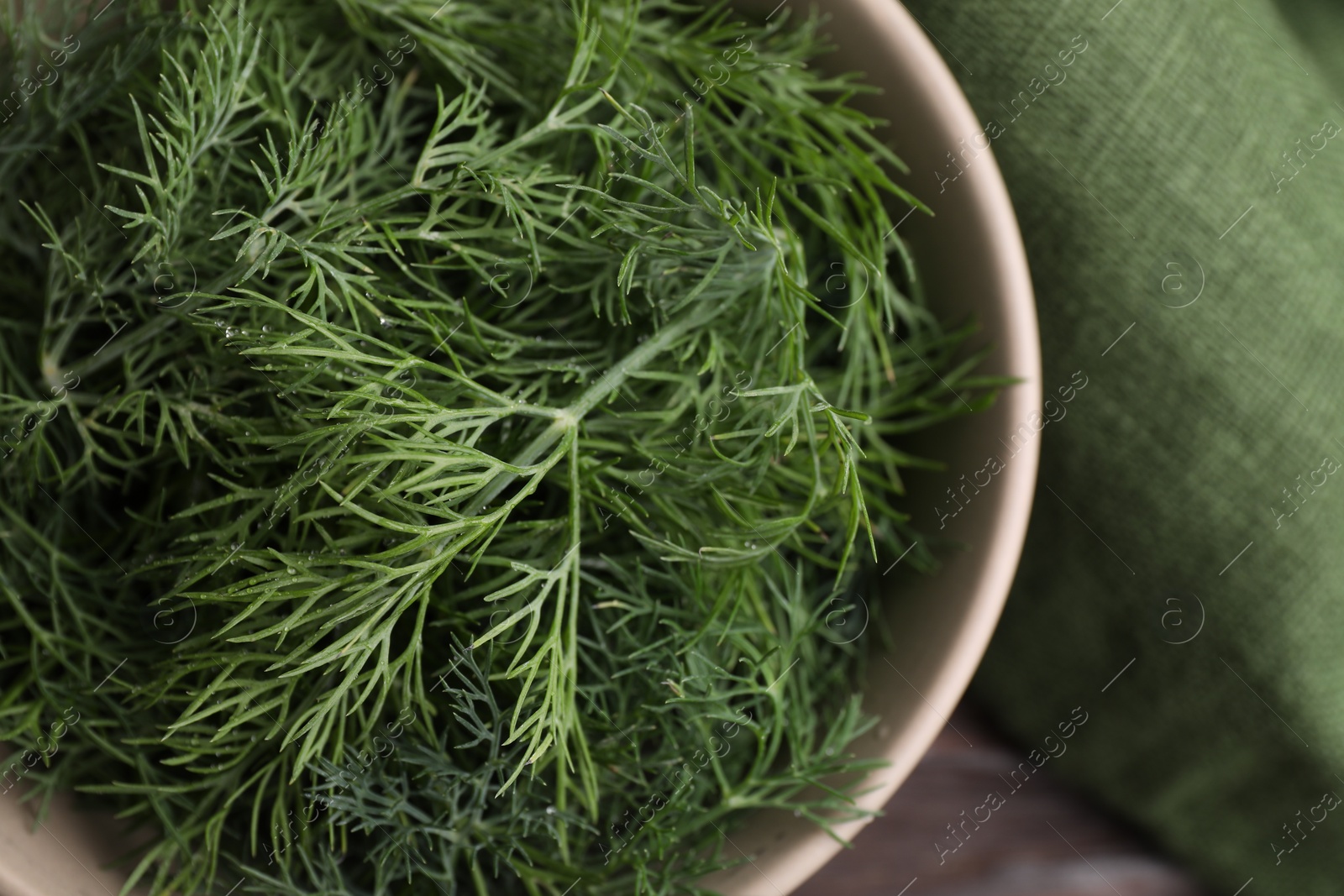 Photo of Bowl of fresh dill on table, top view