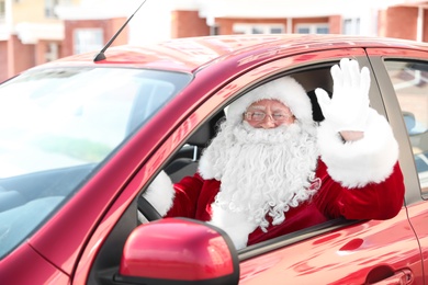 Authentic Santa Claus in car, view from outside