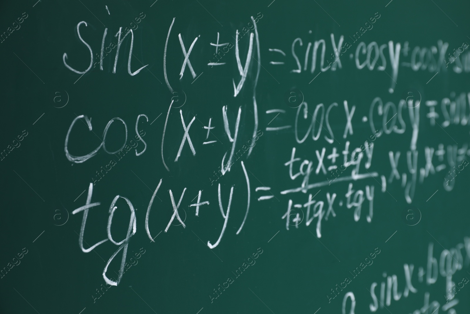 Photo of Many different math formulas written on chalkboard