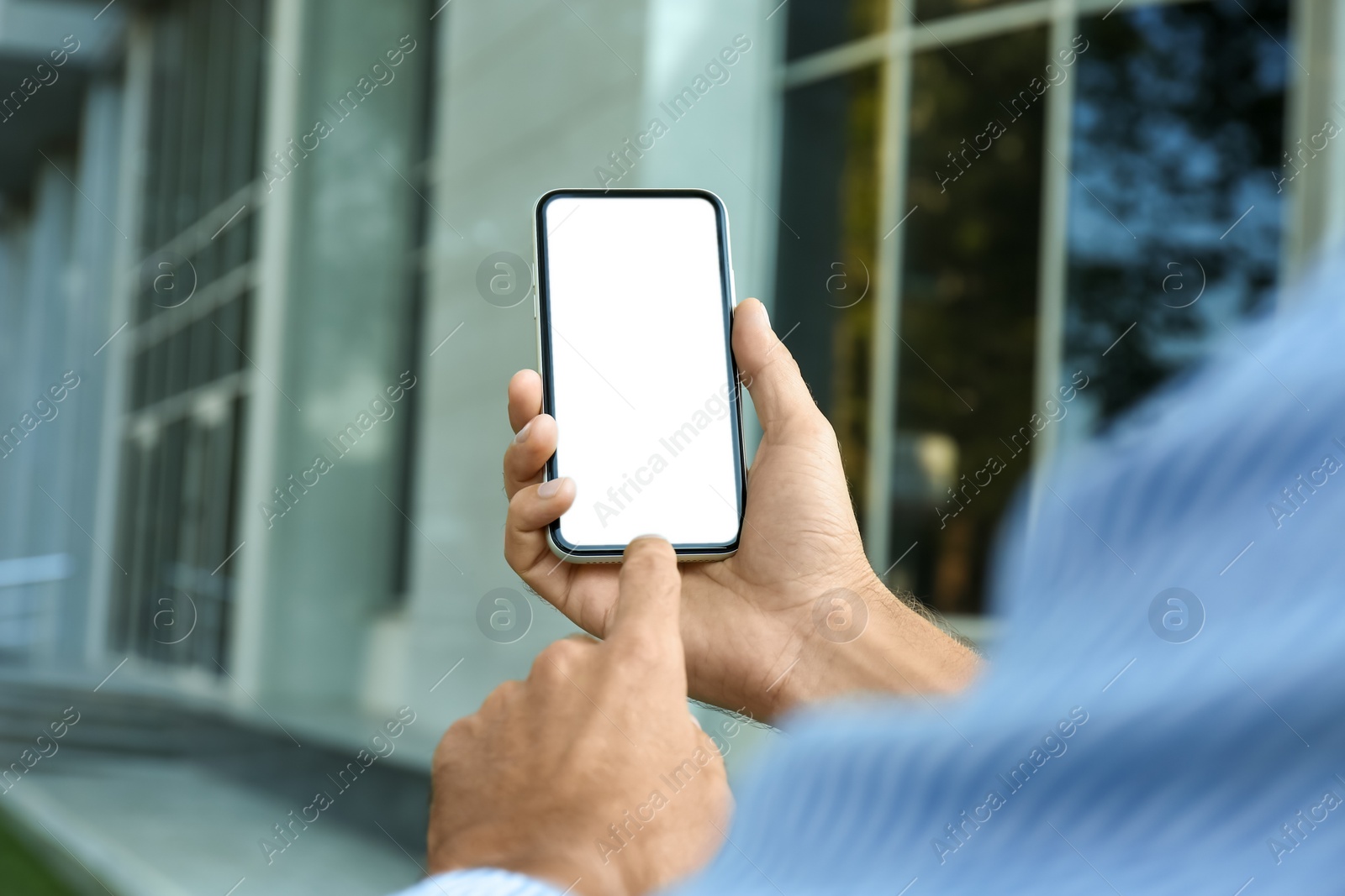 Photo of Man using modern mobile phone outdoors, closeup