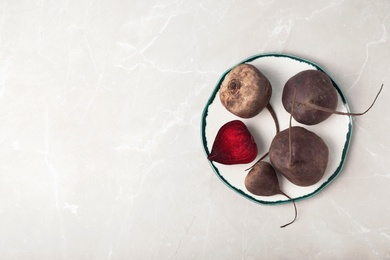 Photo of Plate with beets on grey background, top view