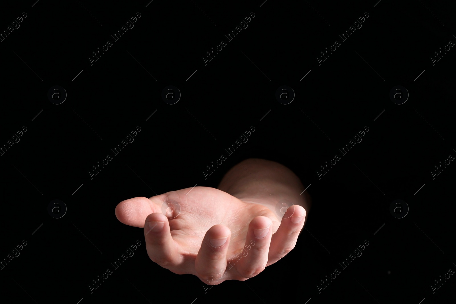Photo of Man throwing game dices on black background, closeup