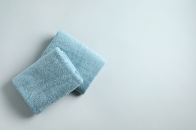 Photo of Fresh fluffy folded towels on grey background, top view. Space for text