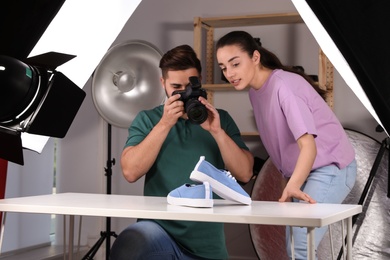 Photo of Professional photographers shooting stylish shoes in studio