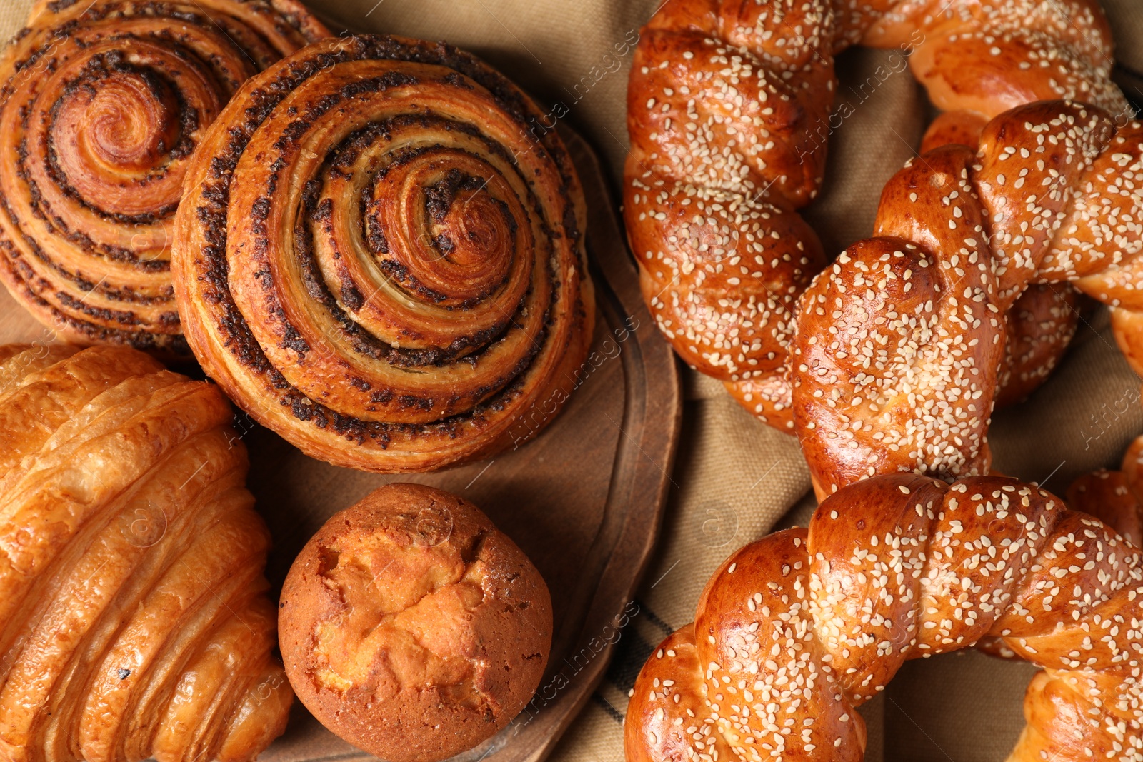 Photo of Different tasty freshly baked pastries on table, flat lay