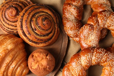 Different tasty freshly baked pastries on table, flat lay