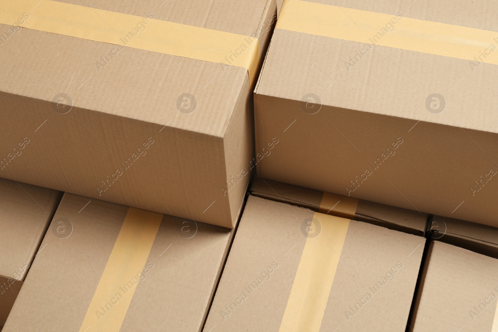 Photo of Many closed cardboard boxes as background. Packaging goods