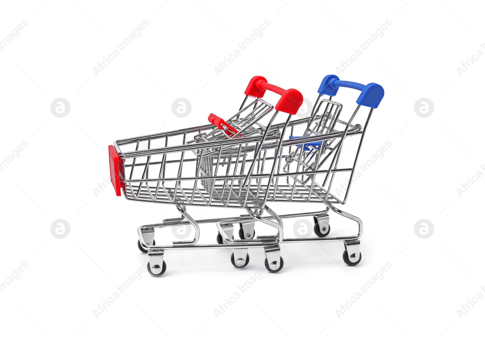 Photo of Empty mini metal shopping carts on white background