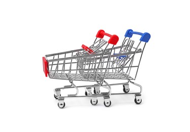 Empty mini metal shopping carts on white background