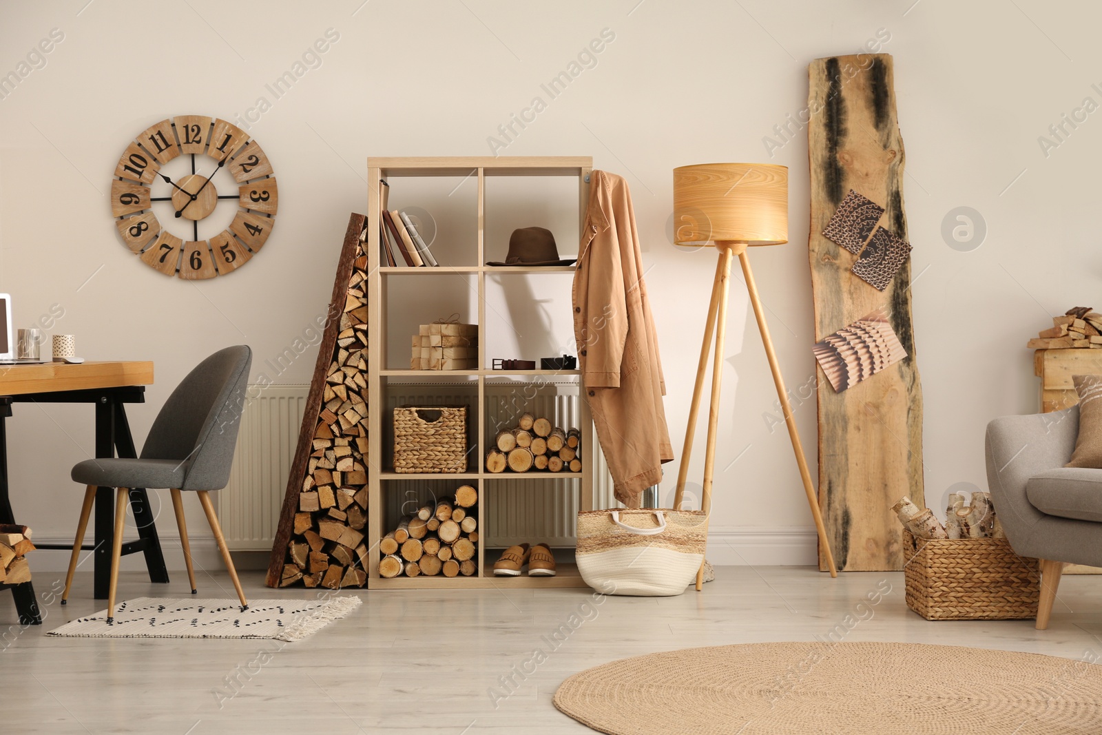 Photo of Stylish room interior with firewood as decorative element