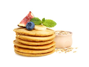 Photo of Tasty oatmeal pancakes and ingredients on white background