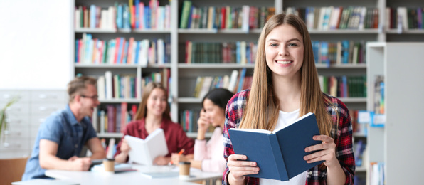 Image of Young student with book in library, space for text. Banner design