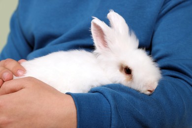 Man with fluffy white rabbit, closeup. Cute pet