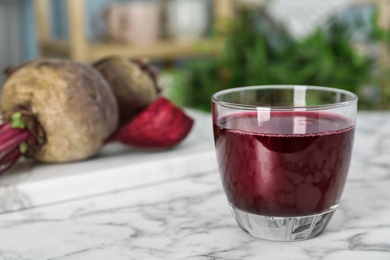 Photo of Glass with fresh healthy beet juice on table