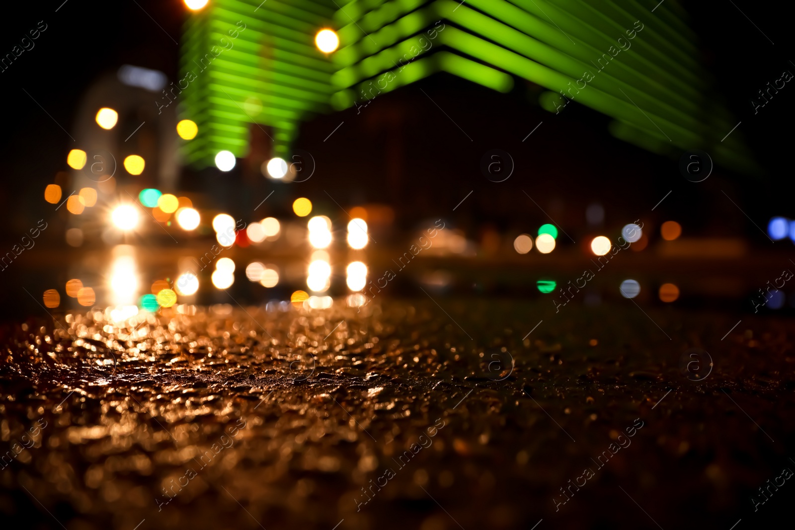 Photo of View of cityscape with bokeh effect, focus on asphalt. Night life