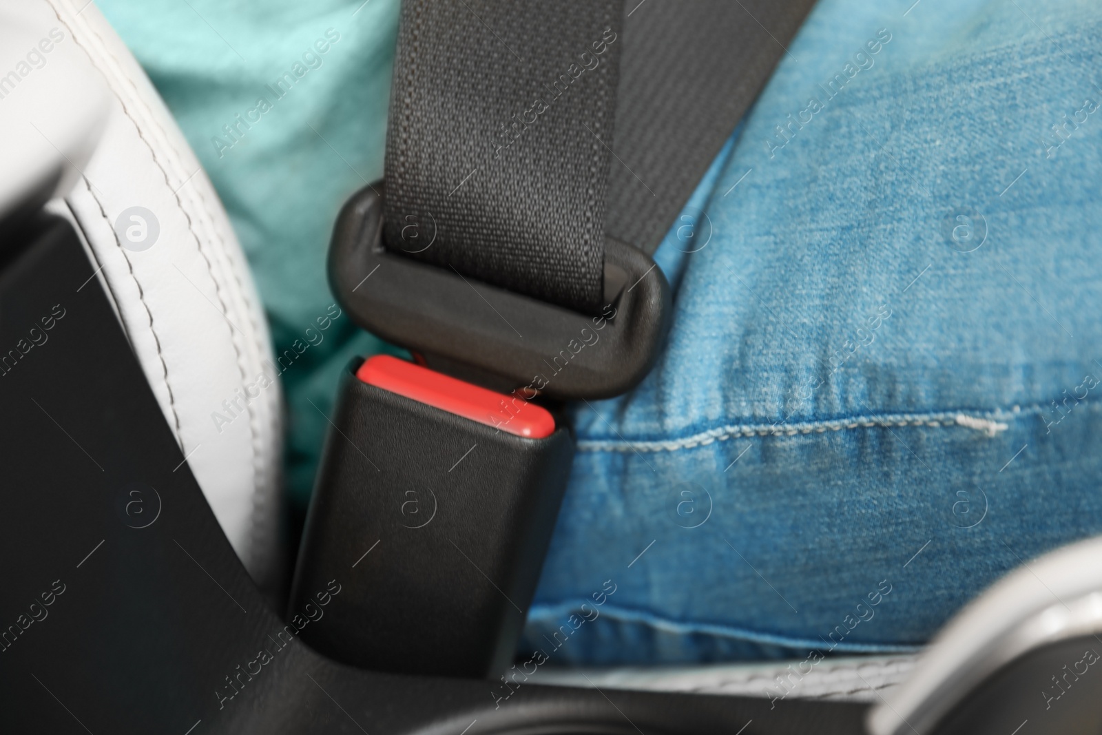 Photo of Driver with fastened safety belt in car, closeup