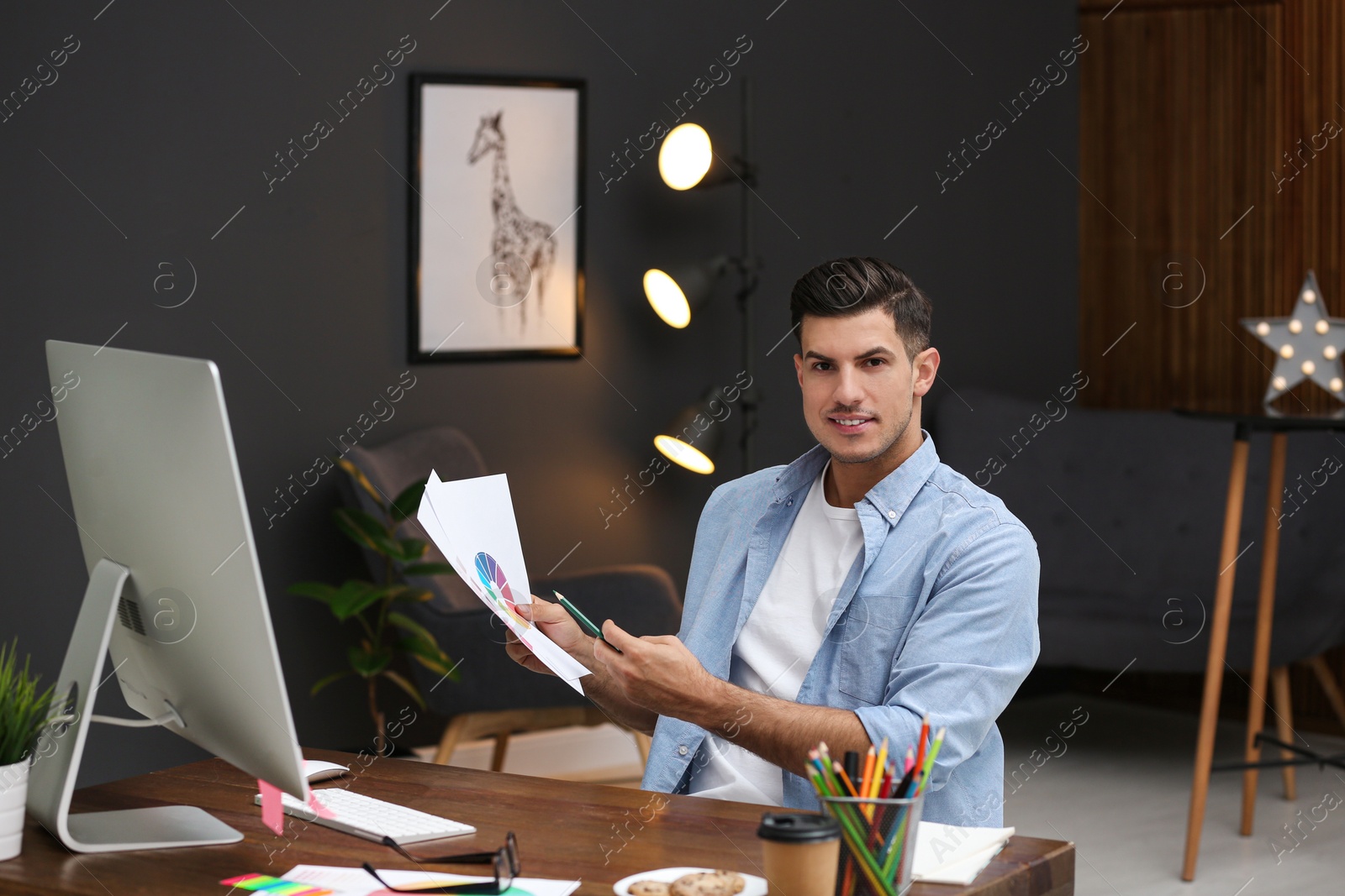 Photo of Male designer working at desk in office