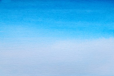 Abstract light blue watercolor painting as background, top view