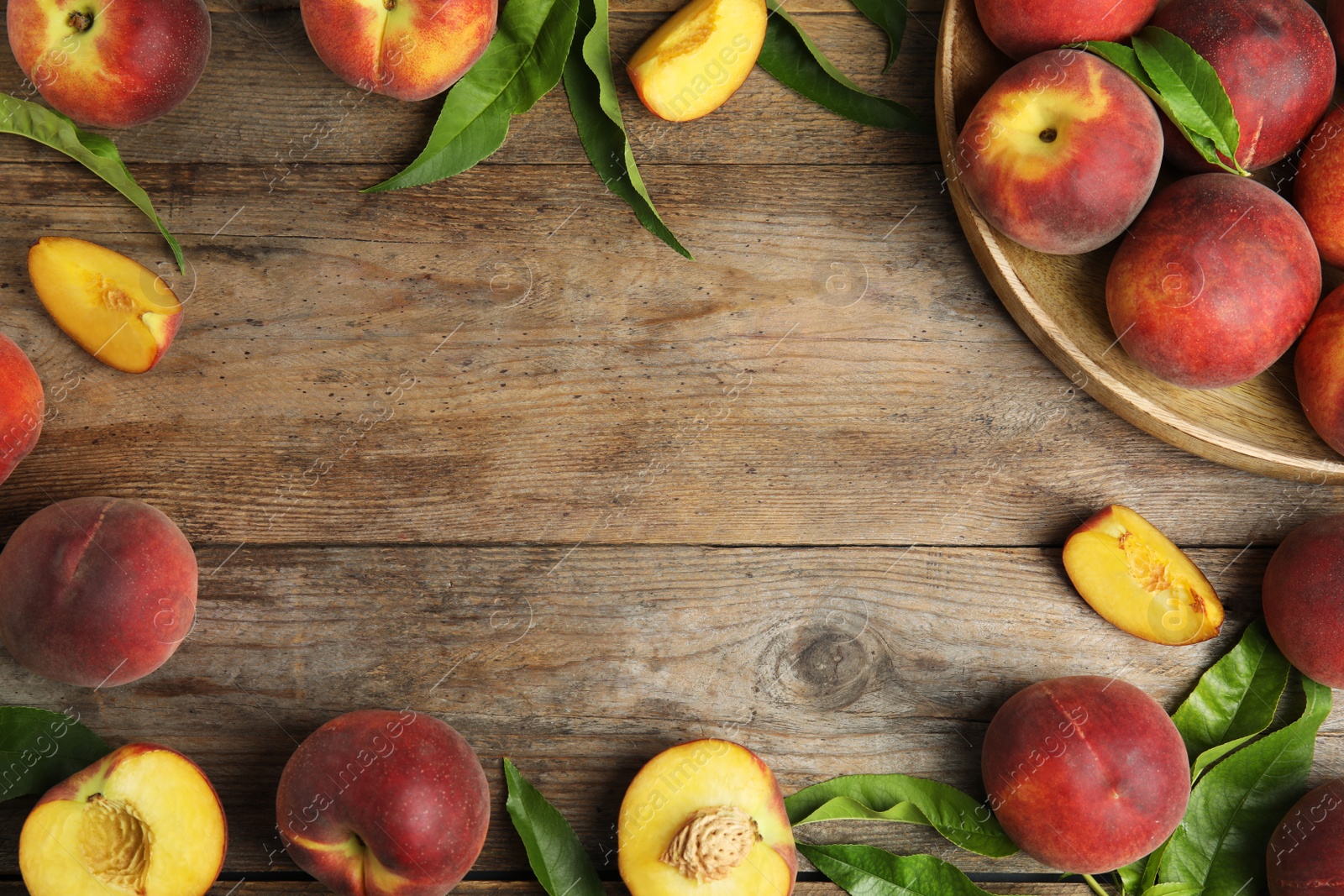 Photo of Flat lay composition with ripe peaches and space for text on wooden background