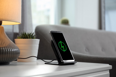 Photo of Smartphone charging on wireless pad in room