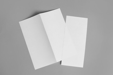 Photo of Blank paper brochures on light grey background, flat lay. Mockup for design
