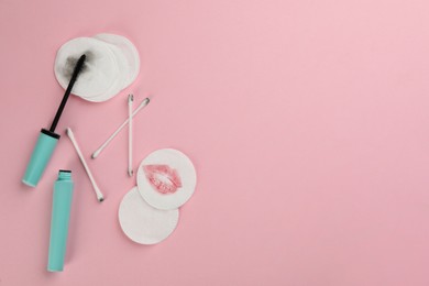 Photo of Clean and dirty cotton pads, swabs with mascara on light pink background, flat lay. Space for text