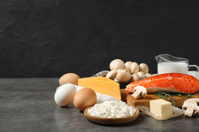 Fresh products rich in vitamin D on grey table