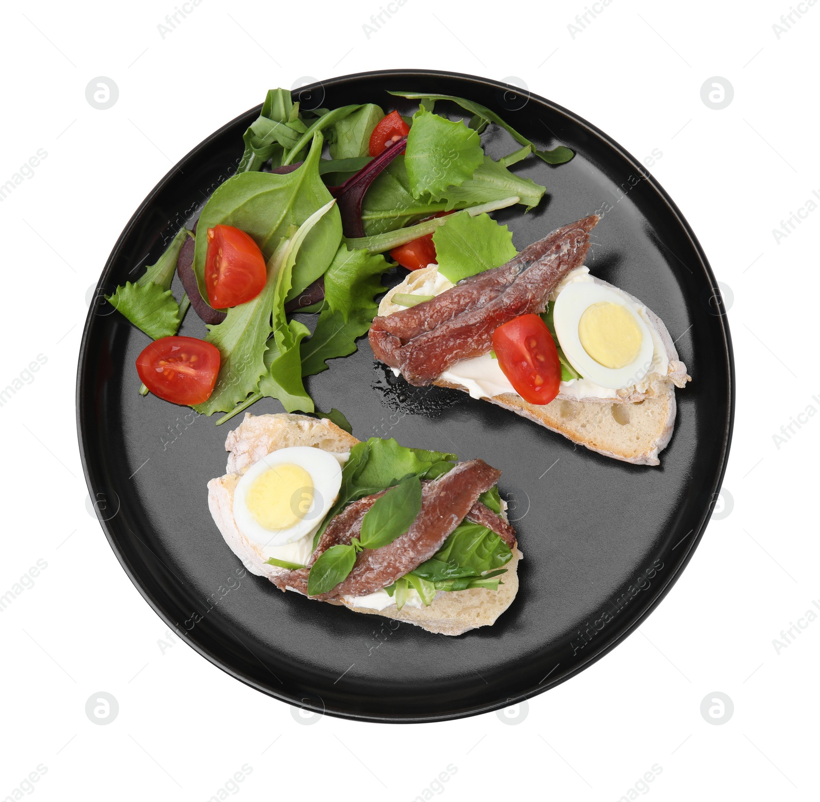 Photo of Delicious bruschettas with anchovies, cream cheese, eggs and tomatoes isolated on white, top view