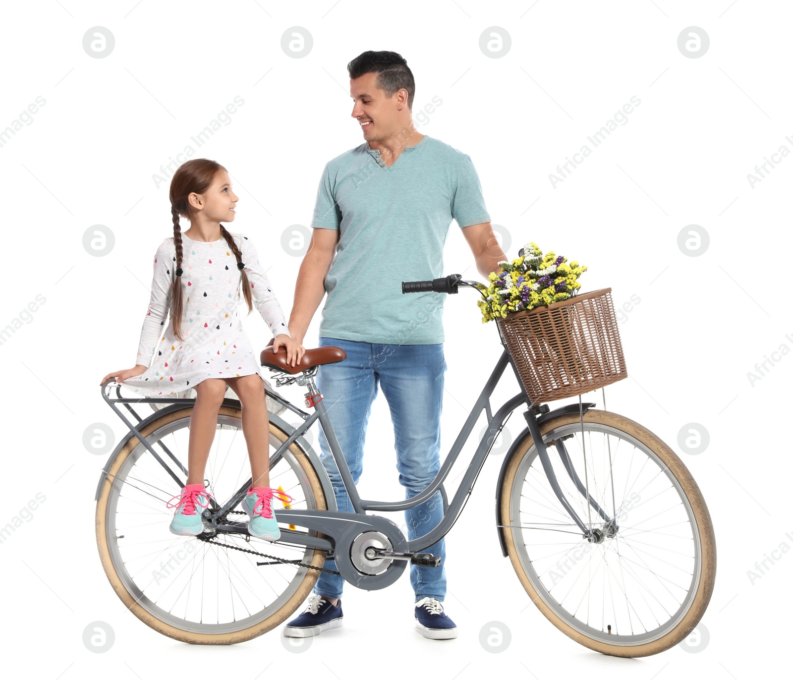 Photo of Portrait of father and his daughter with bicycle on white background