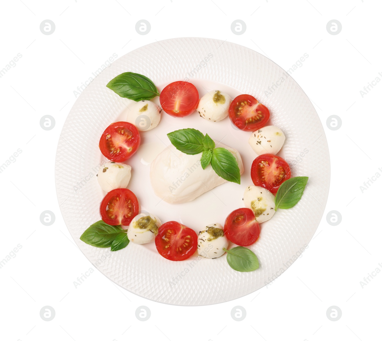 Photo of Plate of tasty Caprese salad with mozzarella, tomatoes, basil and pesto sauce isolated on white, top view