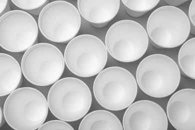 Photo of Many styrofoam cups on light grey background, flat lay