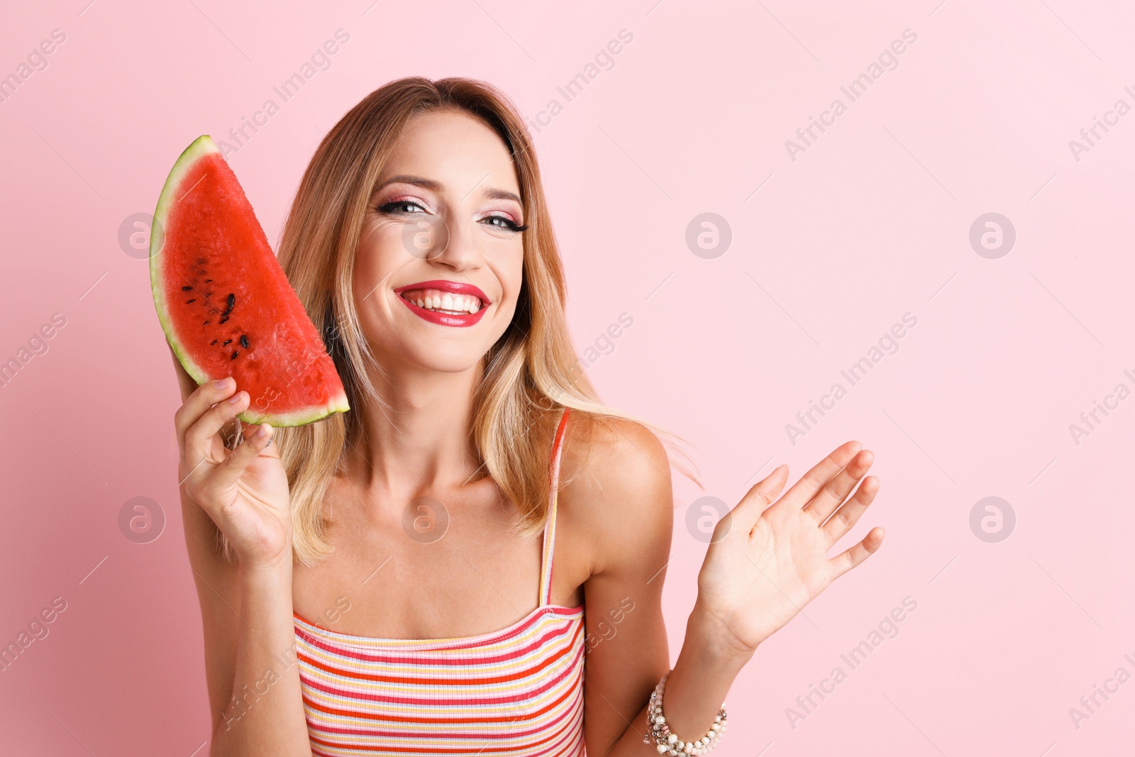 Photo of Pretty young woman with juicy watermelon on color background