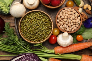 Photo of Different vegetables on wooden table, flat lay. Vegan diet