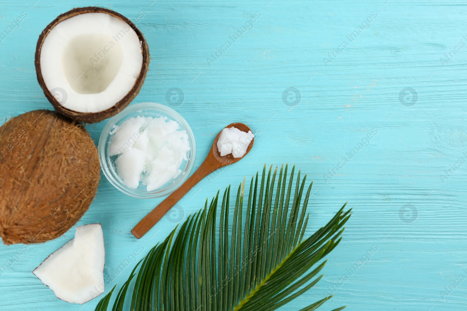 Photo of Flat lay composition with organic coconut oil on light blue wooden table. Healthy cooking