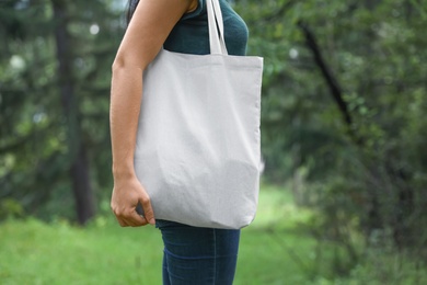 Photo of Woman with eco bag outdoors. Mockup for design