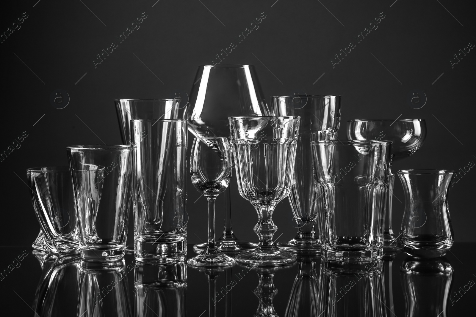 Photo of Empty glasses for different drinks on dark background